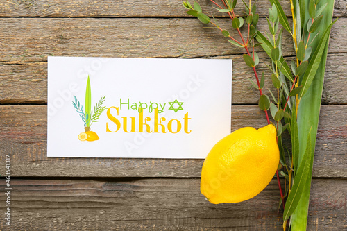 Sukkot festival symbols on wooden background photo