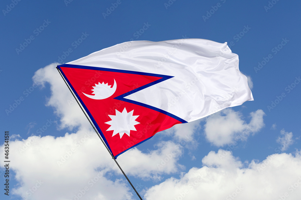 Nepal Flag Isolated On The Blue Sky Background Close Up Waving Flag Of nepal-flag-isolated-on-the-blue-sky-background-close-up-waving-flag-of
