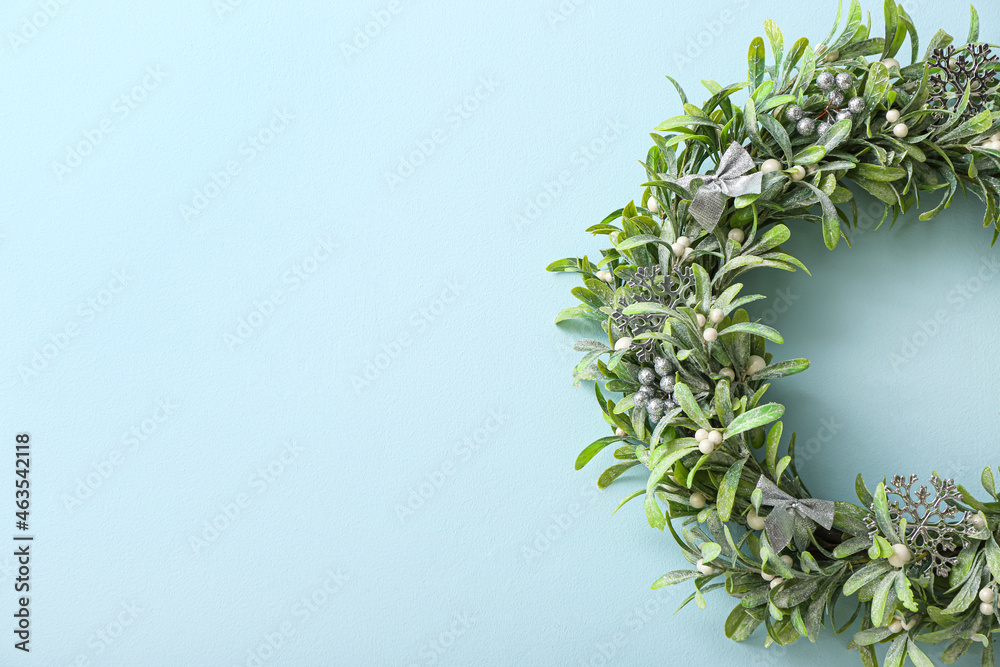 Beautiful mistletoe wreath on color wall Beautiful mistletoe wreath on color wall