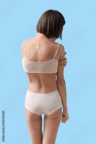 Young skinny woman on color...