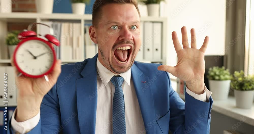 Young businessman looks at the alarm clock and shouts 4k movie Young businessman looks at the alarm clock and shouts 4k movie