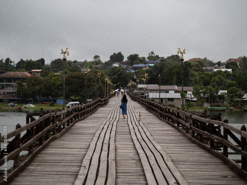 Young beautiful asian woman at Auttamanusorn Wooden Bridge (Sapan Mon) Kanchanaburi , Thailand when she have holiday vacation