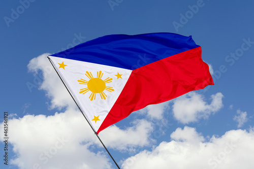 Philippines flag isolated on the blue sky background. close up waving flag of Philippines. flag symbols of Philippines. Concept of Philippines.