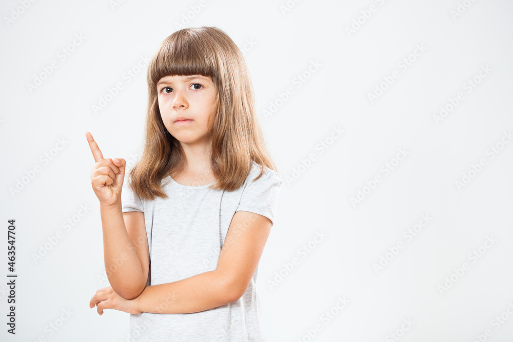 Studio shot portrait of little girl who warns. Copy space on gray background. Studio shot portrait of little girl who warns. Copy space on gray background.