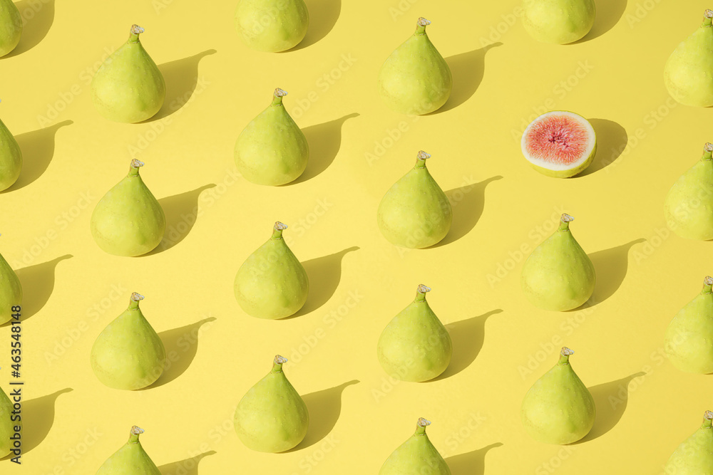 Arranged yellow fig on pastel background. Minimal design. Pattern.