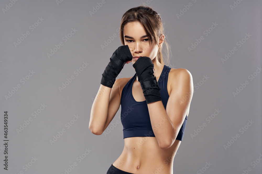 athletic woman boxing punching workout bandages isolated background - obrazy, fototapety, plakaty 