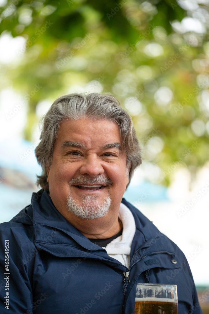 Head shot of a man outside while having a glass of beer Head shot of a man outside while having a glass of beer
