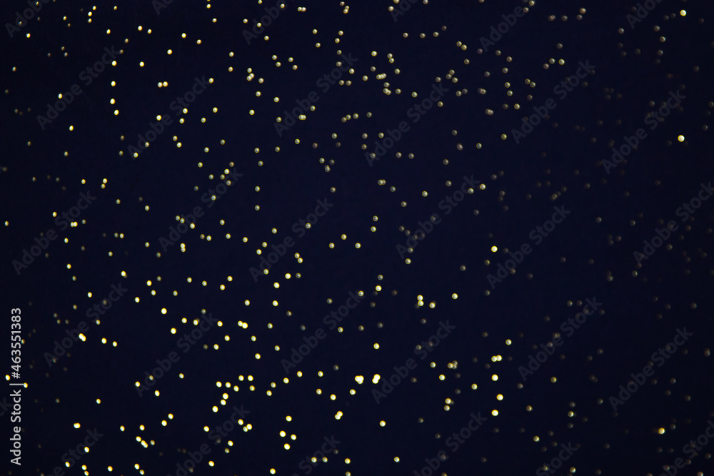Black bokeh texture on black background. Dark background with small lights. Black bokeh texture on black background. Dark background with small lights.