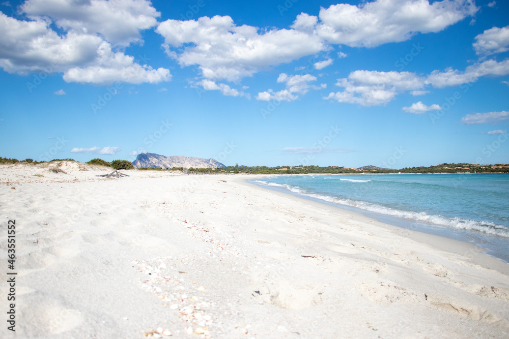 White empty beach landscape. La Cinta, San Teodoro, Sardegna, Italy. Blue sky, clouds