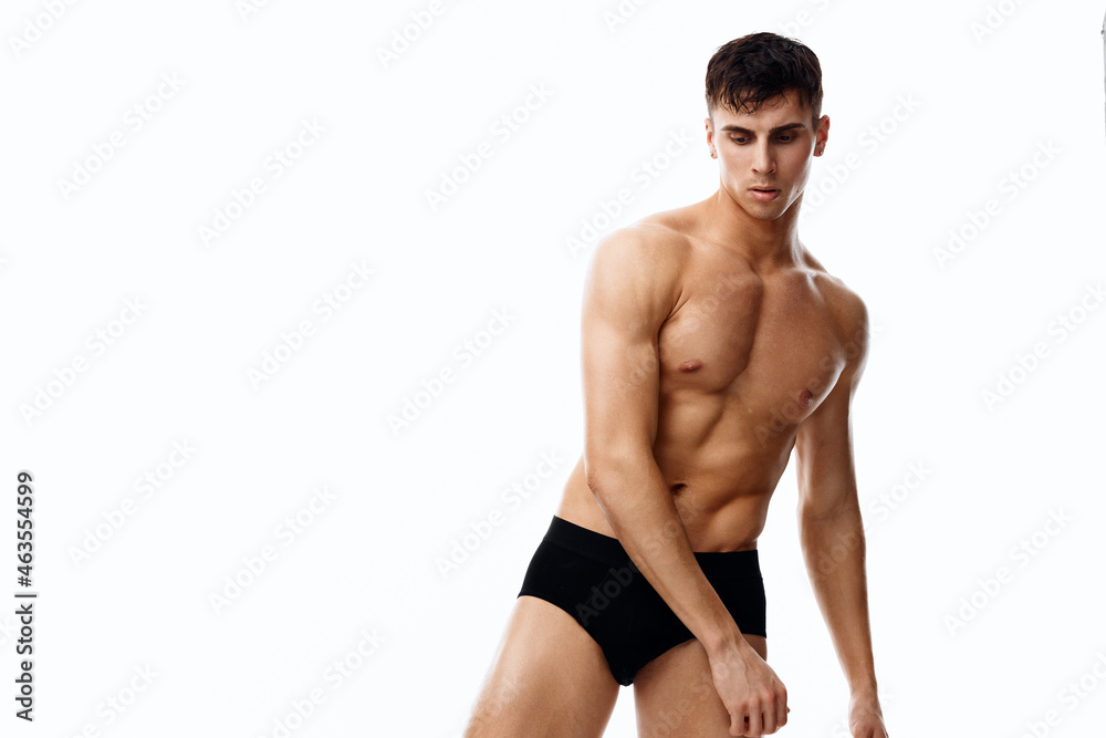 naked athlete with a pumped-up torso and in black panties leaned to the side cropped view naked athlete with a pumped-up torso and in black panties leaned to the side cropped view
