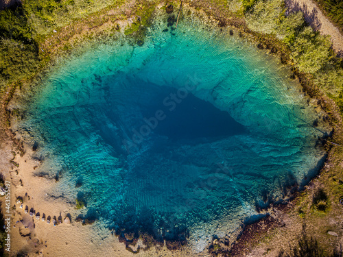 The spring of the Cetina River, izvor Cetine, in the foothills of the Dinara Mountain is named Blue Eye, Modro oko. Cristal clear waters emerge on the surface from a more than 100 meter-deep shaft. photo