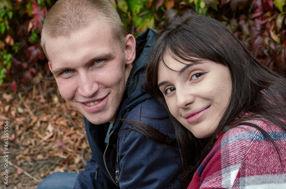 Young family. A heterosexual couple in love in front of a hedge. Young family. A heterosexual couple in love in front of a hedge.