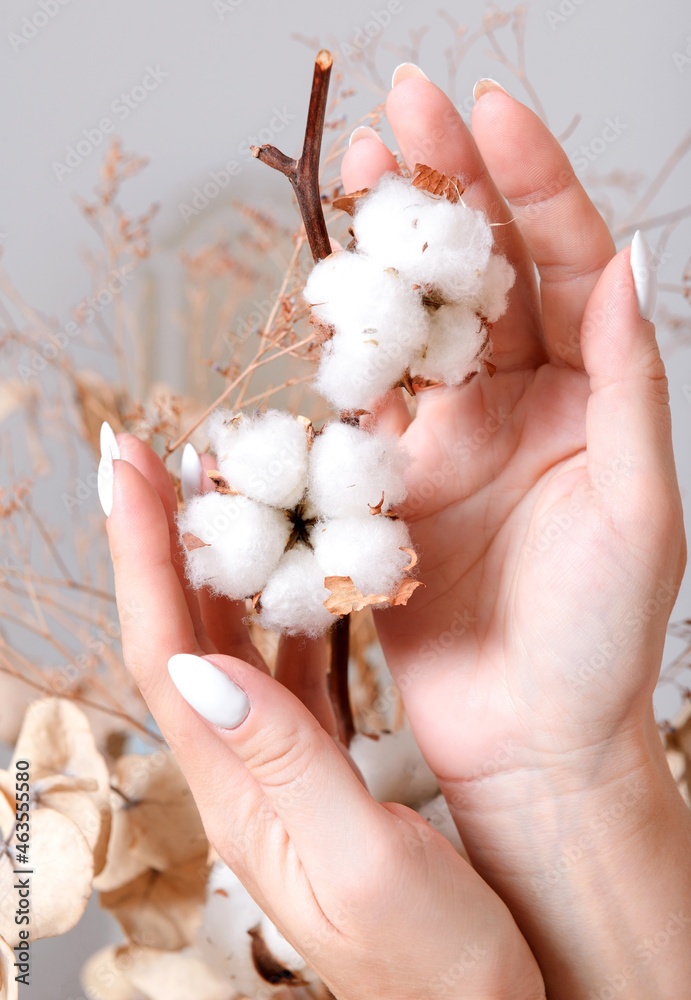 Woman's hands touching white cotton Woman's hands touching white cotton