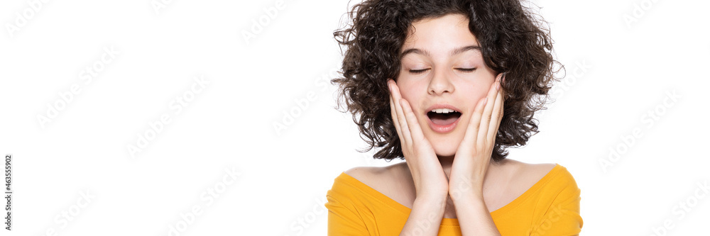 Shocked happy teenager with head in hands looking at camera in disbelief, isolated over white background. Surprised young girl studio shot background. Shocked happy teenager with head in hands looking at camera in disbelief, isolated over white background. Surprised young girl studio shot background.