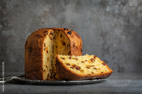 Panettone, italian type of sweet bread with raisins originally from Milan, Christmas and New Year food. Gray background.