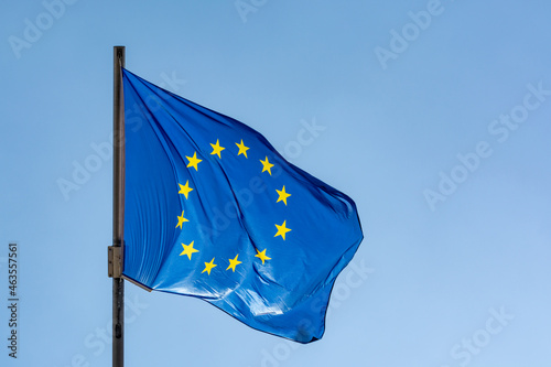 Blue with yellow stars flag of European Union waving on flagpole