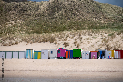 Small beach huts on white sandy beach North sea beach near Zoutelande, Zeeland, Netherlands photo