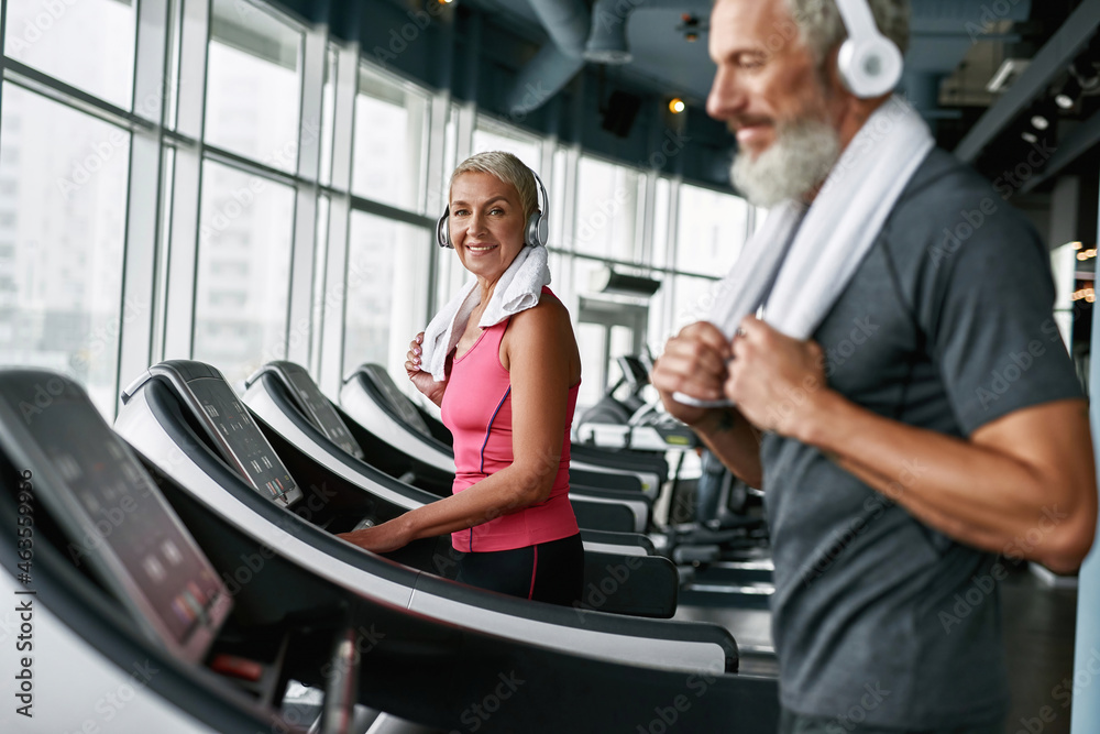 Healthy lifestyle concept. Mature woman working out on treadmill Healthy lifestyle concept. Mature woman working out on treadmill