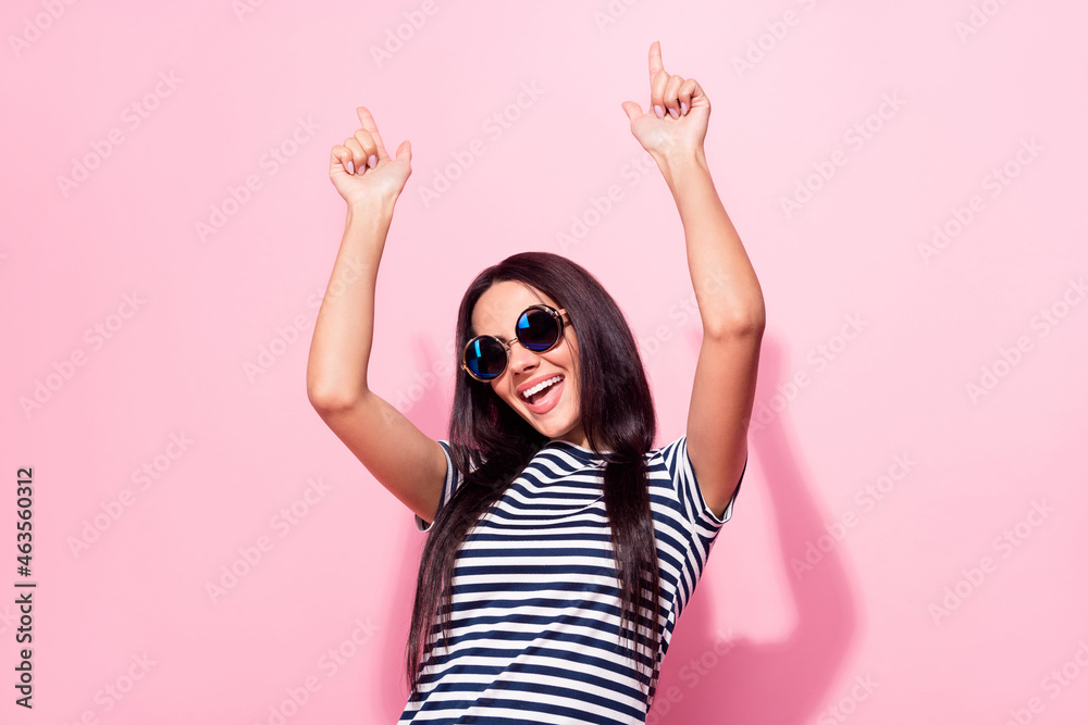 Photo of dreamy cheerful young woman wear cool sunglass dance smile isolated on pink color background