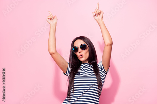 Portrait of attractive cheerful woman dancing having fun pout lips isolated over pink pastel color background © deagreez