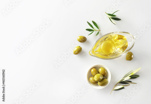 Olive branch and olive oil isolated on white background. Top view