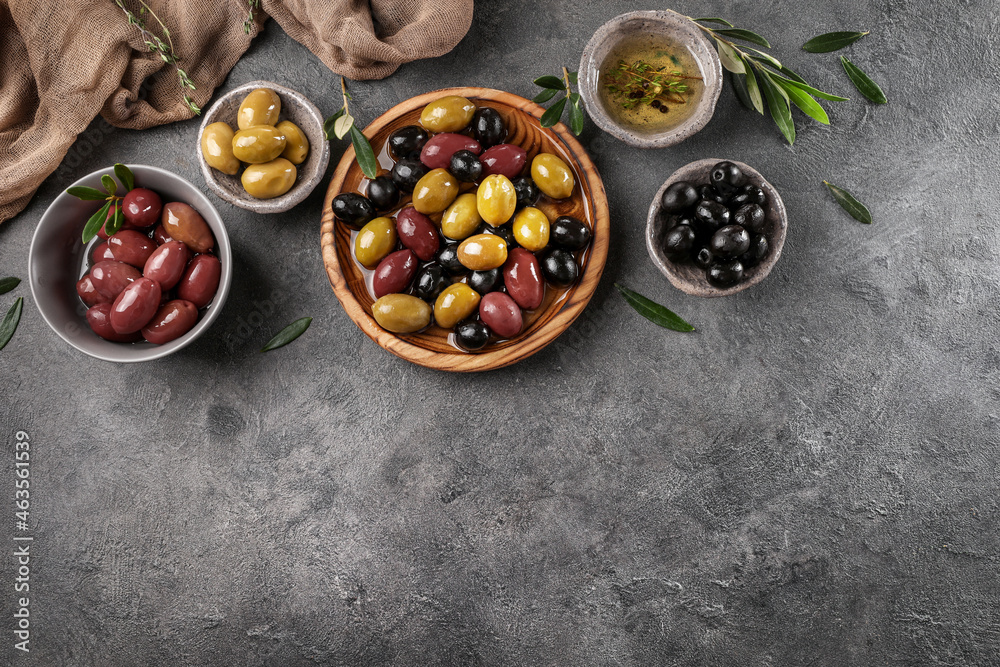 Green, black and red olives and olive oil on stone table. Top view Green, black and red olives and olive oil on stone table. Top view
