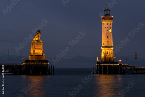 lighthouse and lion at largest german lake with mountains in the background at night 