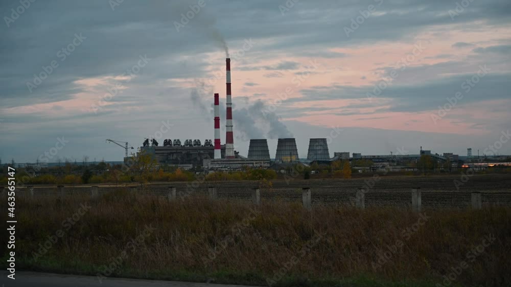 Smoke coming out from the chimneys of the CHP plant, autumn evening Smoke coming out from the chimneys of the CHP plant, autumn evening