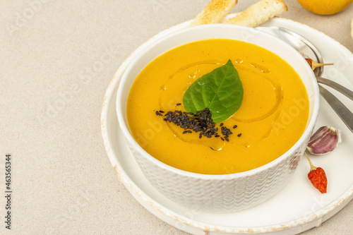Pumpkin cream soup. Traditional autumn food. Hot dish, ripe vegetables, fragrant spices