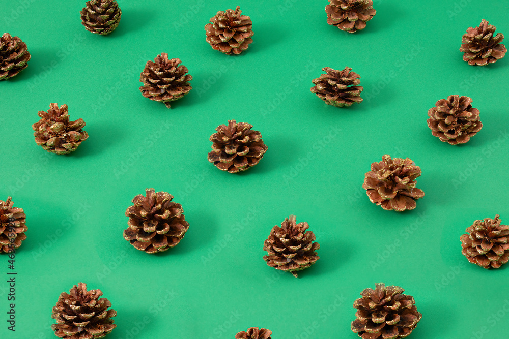 Obraz premium Vintage Christmas pattern creative concept of glitter pinecone on pastel green background. New year is coming.