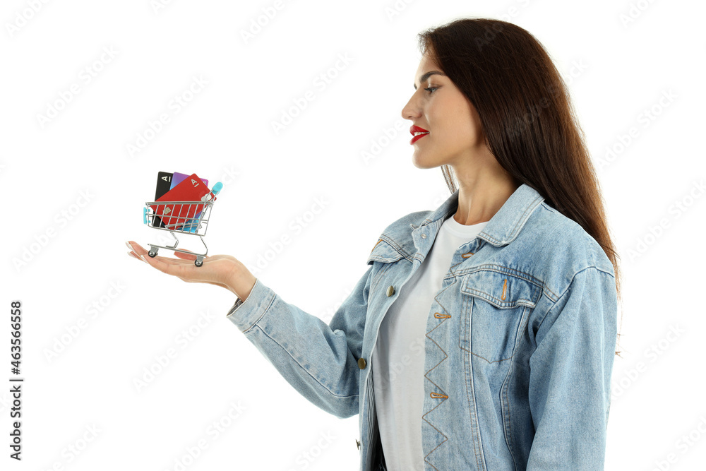 Girl holds shop trolley with credit cards, isolated on white background Girl holds shop trolley with credit cards, isolated on white background
