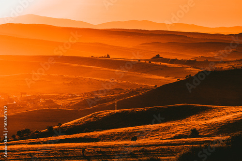 autumn landscape with hills in sunset light