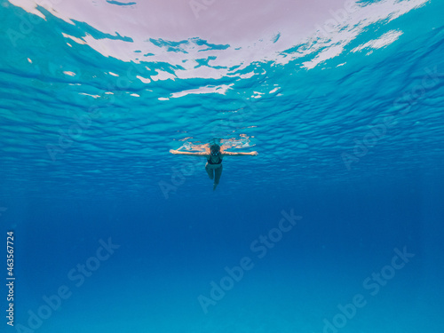 Underwater photo of beautiful woman snorkeling