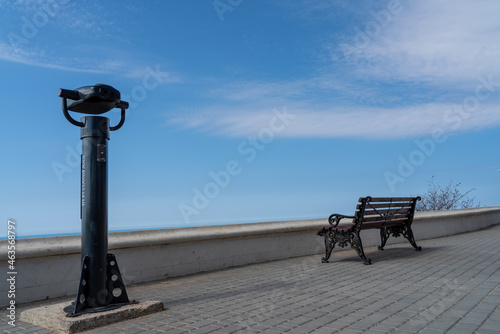 Coin-operated binoculars with sea view on the waterfront. The blue sea with the horizon. photo