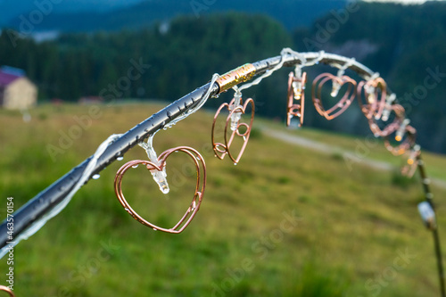 Lights decoration hanging on a wire, outside in mountains area, rainy day