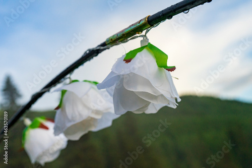 Lights decoration hanging on a wire, outside in mountains area, rainy day