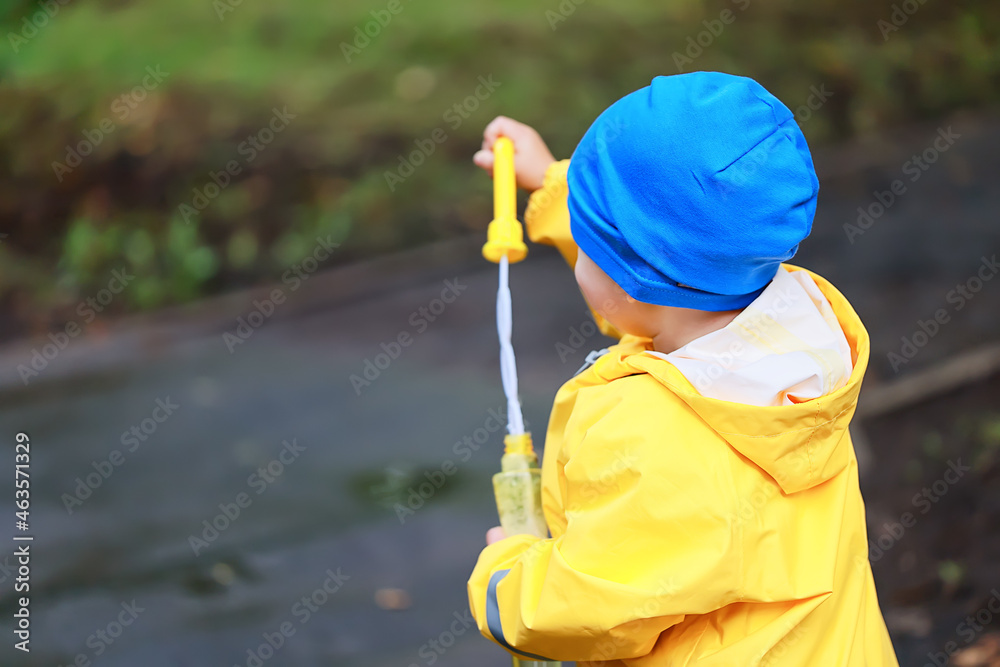 yellow raincoat boy look, autumn seasonal walk in the park yellow raincoat boy look, autumn seasonal walk in the park