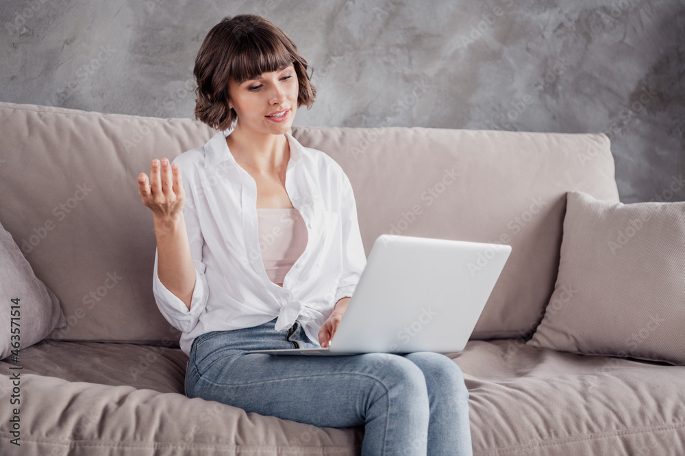 Photo of serious charming attractive woman hold hand laptop meeting online indoors inside house home apartment