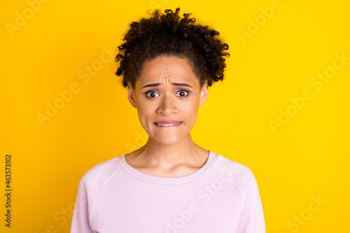 Portrait of horrified dark skin people biting lip look camera panic isolated on bright color background © deagreez