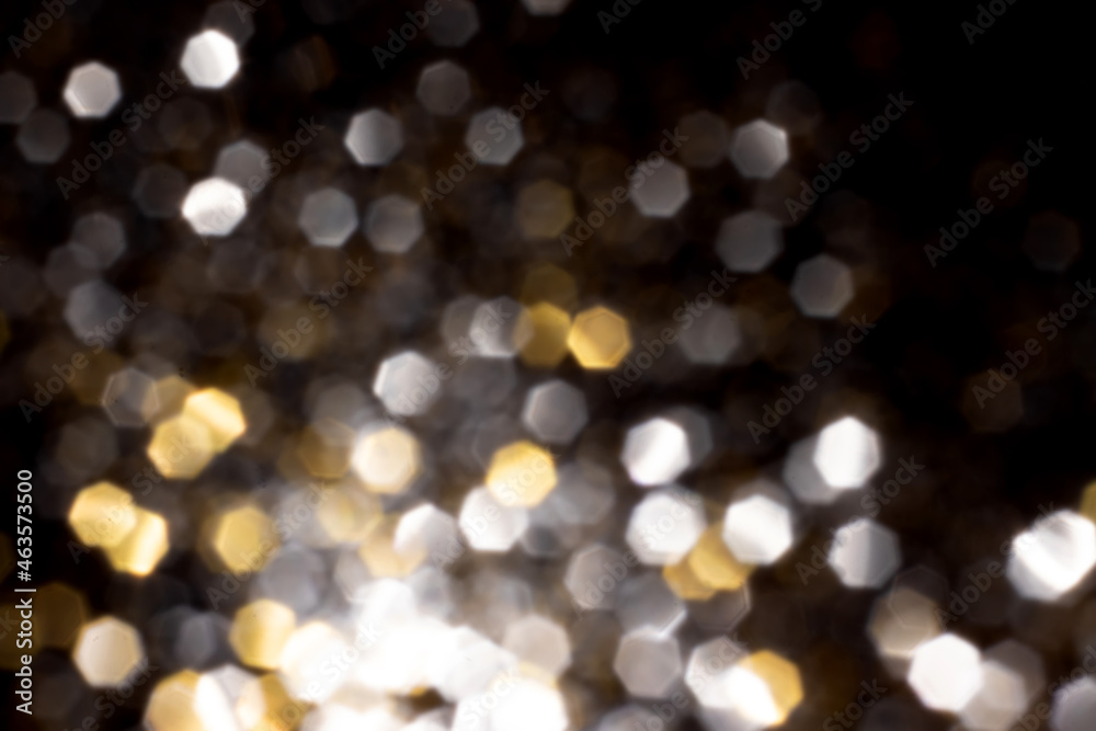 Golden and silver blurred bokeh lights on black background. Glitter sparkle stars for celebrate. Overlay for your design