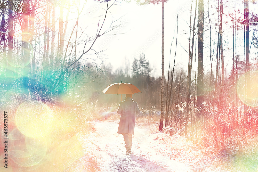 Fototapeta premium winter walk with an umbrella / man in a coat with an umbrella, walk against the backdrop of the winter landscape, winter view