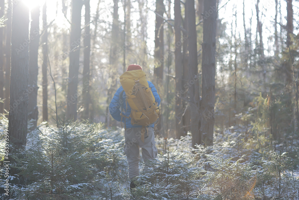 winter landscape forest backpack man / traveler in modern winter clothes in the forest, traveling in the mountains europe, switzerland winter winter landscape forest backpack man / traveler in modern winter clothes in the forest, traveling in the mountains europe, switzerland winter