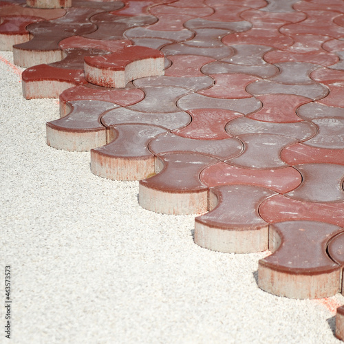 Pavement of urban sidewalk with red concrete pavers. Paving street sidewalk with red concrete pavers. 