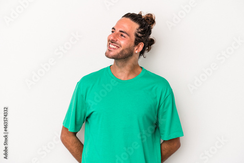 Young caucasian man isolated on white background relaxed and happy laughing, neck stretched showing teeth.