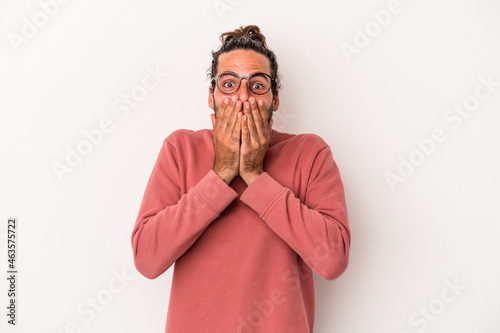 Young caucasian man isolated on white background shocked  covering mouth with hands  anxious to discover something new.
