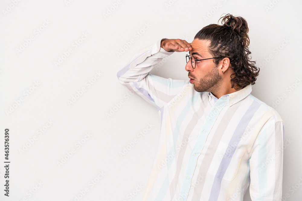 Young caucasian man isolated on gray background looking far away keeping hand on forehead. Young caucasian man isolated on gray background looking far away keeping hand on forehead.