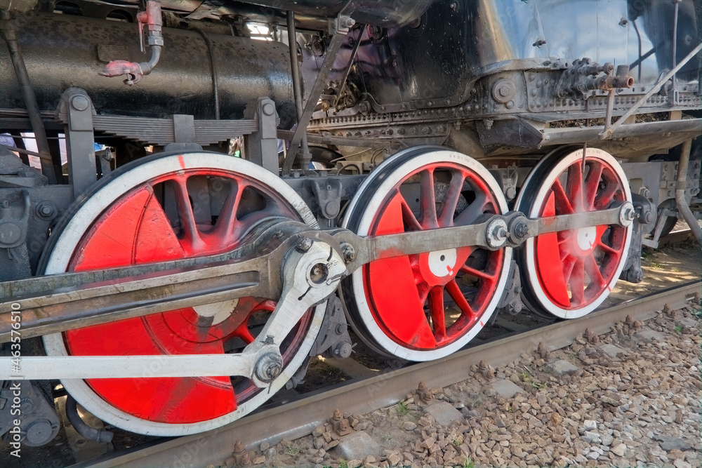 Fragment of an old steam locomotive close-up. Steam locomotive wheels.