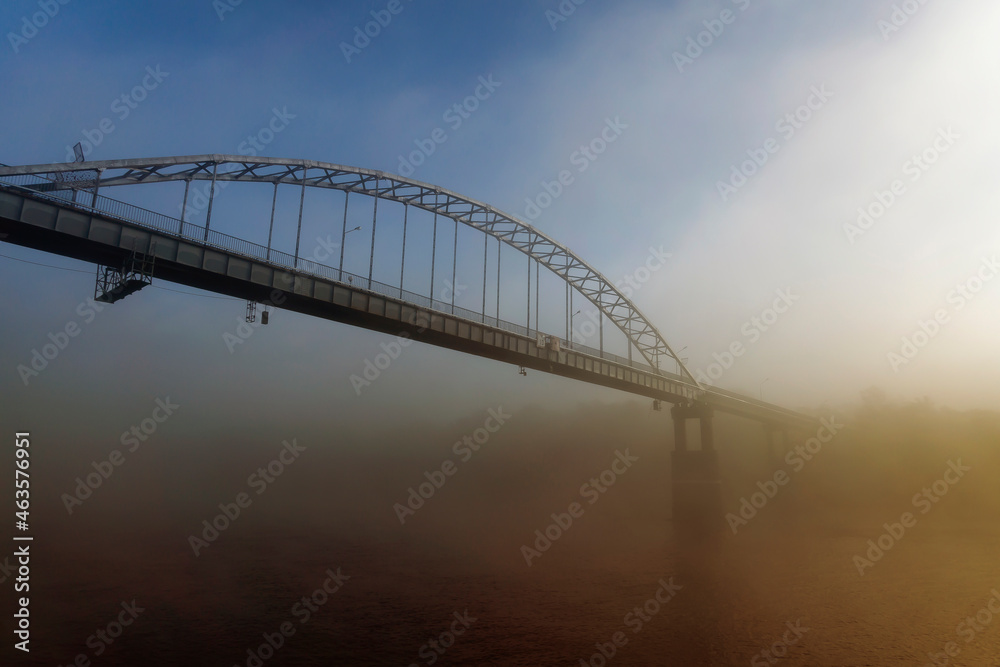 Peizaz on a beautiful foggy autumn morning and a bridge over the river. Gomel.