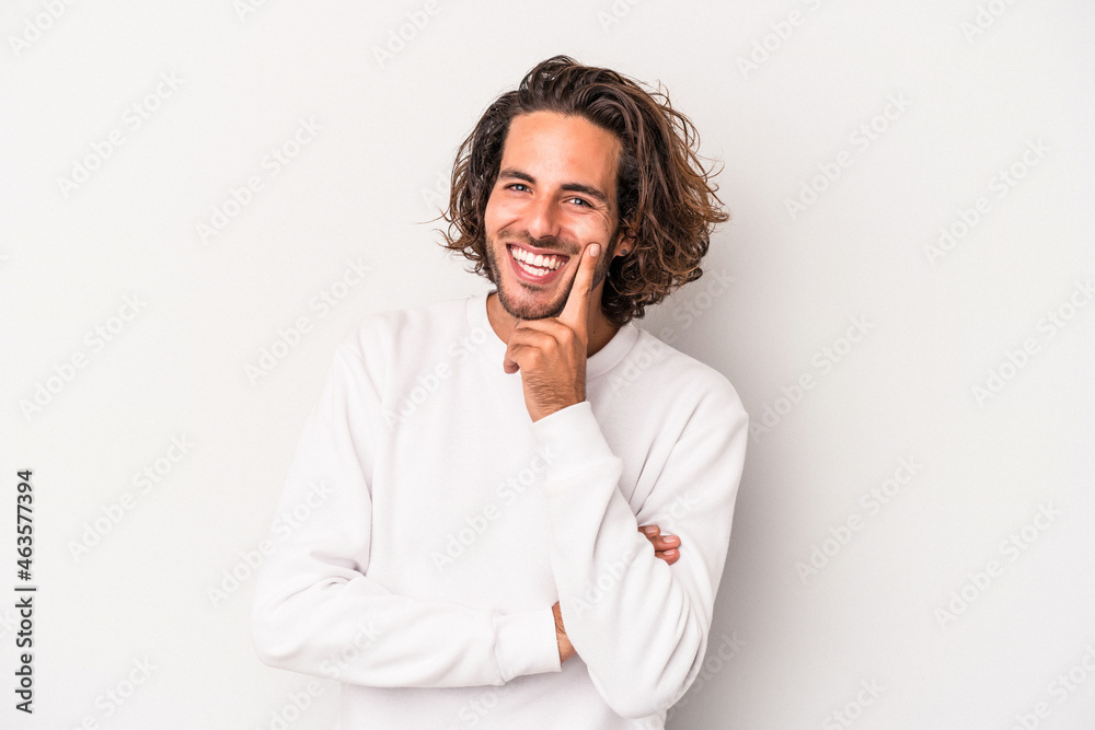 Young caucasian man isolated on gray background smiling happy and confident, touching chin with hand. Young caucasian man isolated on gray background smiling happy and confident, touching chin with hand.
