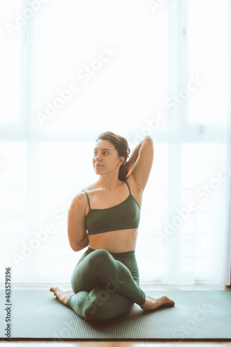 woman do yoga at home near big window